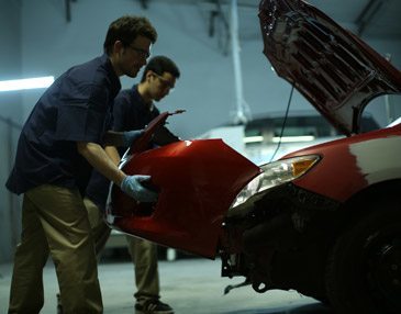 Maaco employees repair collision damage